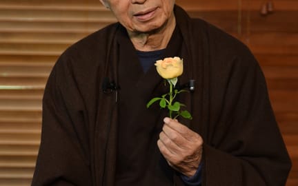 Thich Nhat Hanh looking flower