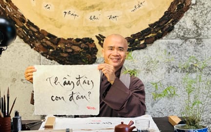 Thay Phap Niem writing calligraphy in the new Thich Nhat Hanh Museum in Hue