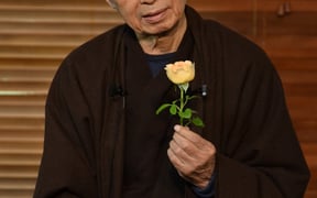 Thich Nhat Hanh looking flower