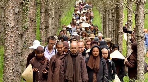 Plum Village Practice Center Thich Nhat Hanh leading walking meditation in Plum Village France