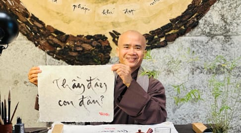 Thay Phap Niem writing calligraphy in the new Thich Nhat Hanh Museum in Hue