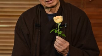 Thich Nhat Hanh looking flower