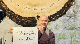 Thay Phap Niem writing calligraphy in the new Thich Nhat Hanh Museum in Hue
