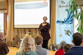 Dr. Juliet Hwang showing nervous system regulation techniques at The Buddha the Scientist Retreat, Deer Park Monastery, 2022