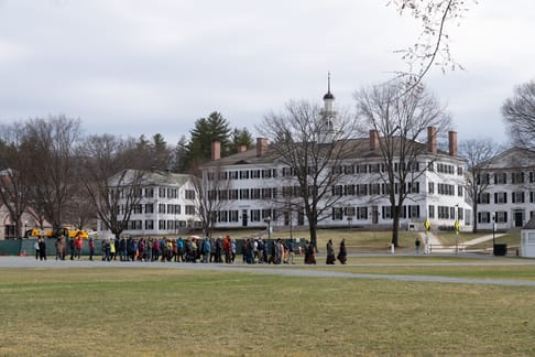 Monastics leading walking meditation in front of Dartmouth Hall